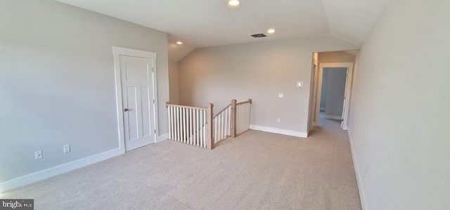 unfurnished room with carpet floors and lofted ceiling