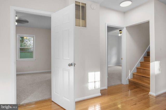 hallway featuring light colored carpet