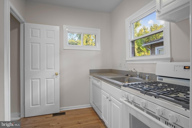 kitchen featuring range, white cabinets, sink, light hardwood / wood-style floors, and white dishwasher