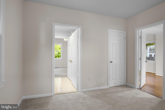 unfurnished bedroom featuring wood-type flooring and ensuite bathroom