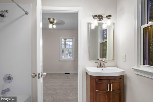 bathroom with vanity with extensive cabinet space, shower / bath combination, and ceiling fan