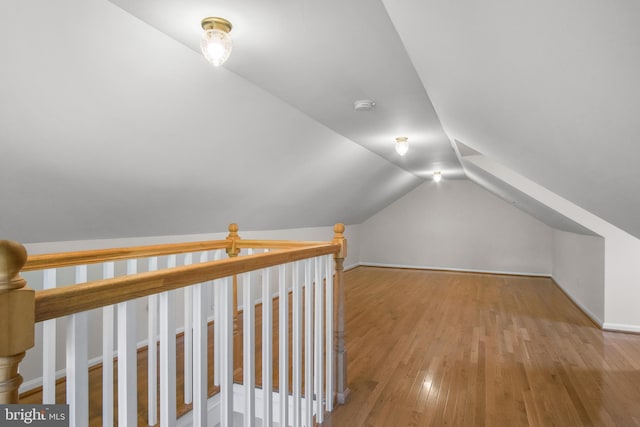 bonus room with lofted ceiling and hardwood / wood-style flooring