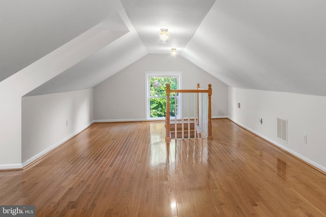 bonus room featuring hardwood / wood-style floors and vaulted ceiling