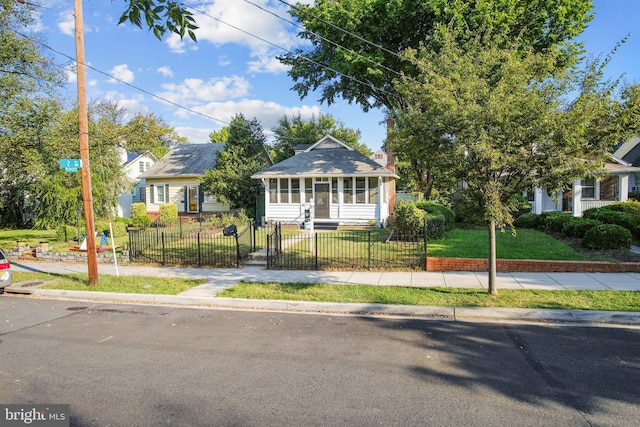 bungalow-style house featuring a front yard