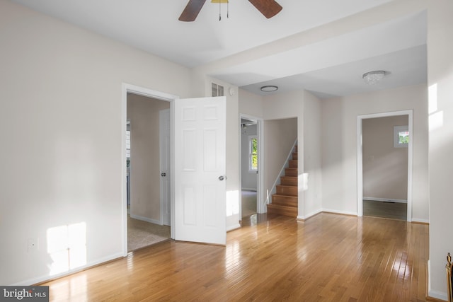 unfurnished room with ceiling fan and light wood-type flooring