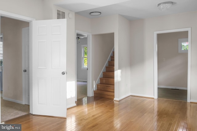 staircase featuring light carpet and ceiling fan