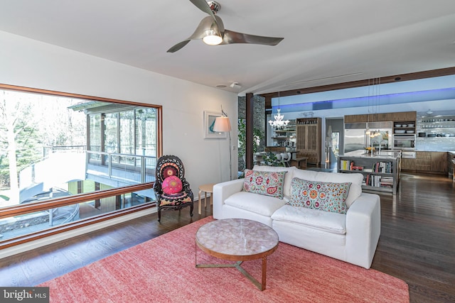 living room featuring ceiling fan with notable chandelier and dark wood-type flooring