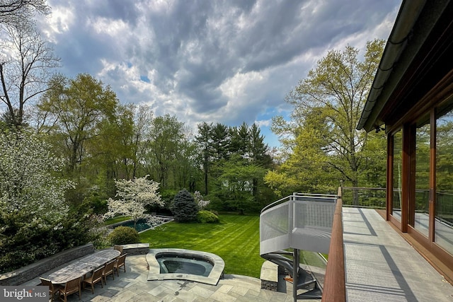 exterior space featuring an outdoor hot tub