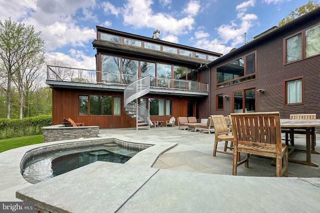 back of property with a patio area and a balcony