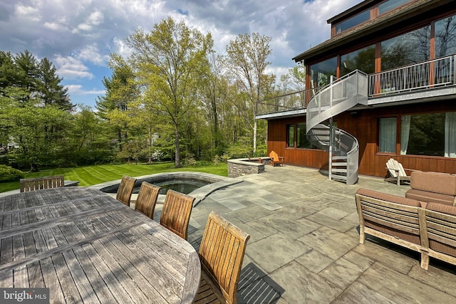 exterior space featuring a patio area and a swimming pool with hot tub