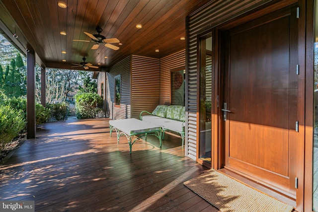 wooden terrace featuring ceiling fan