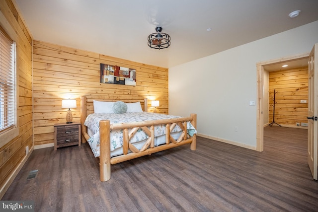 bedroom featuring wood walls and dark hardwood / wood-style floors