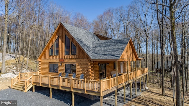 rear view of property with a wooden deck