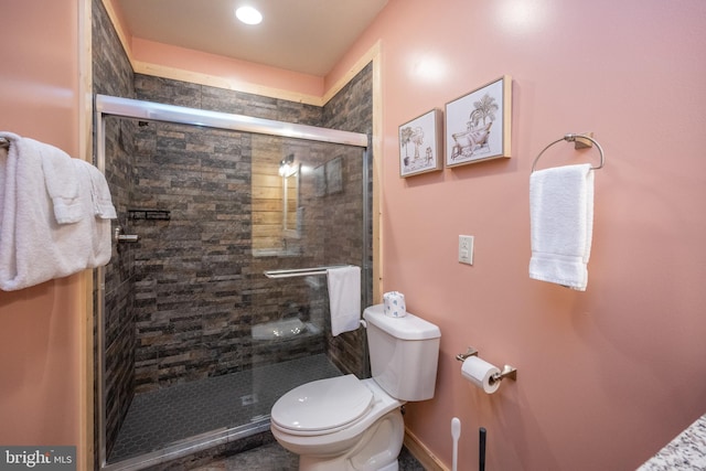 bathroom featuring an enclosed shower and toilet