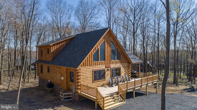 rear view of house featuring central air condition unit and a wooden deck