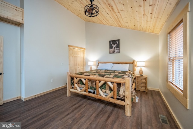 bedroom with dark hardwood / wood-style floors, a closet, vaulted ceiling, and wooden ceiling