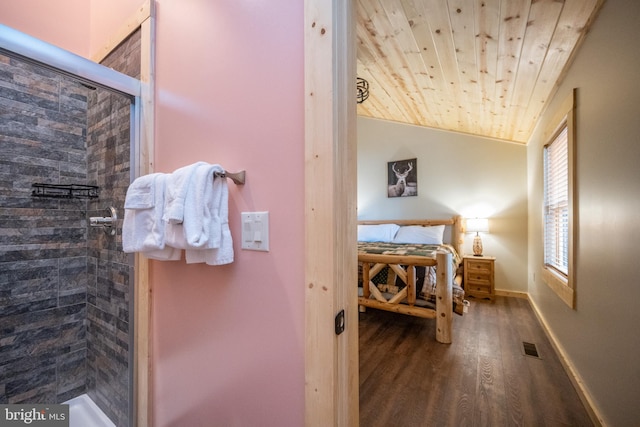 bathroom featuring wood-type flooring, tiled shower, and wood ceiling