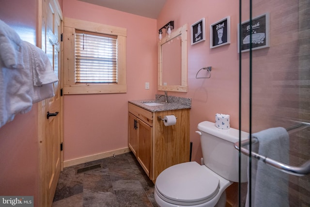 bathroom with tile flooring, large vanity, and toilet