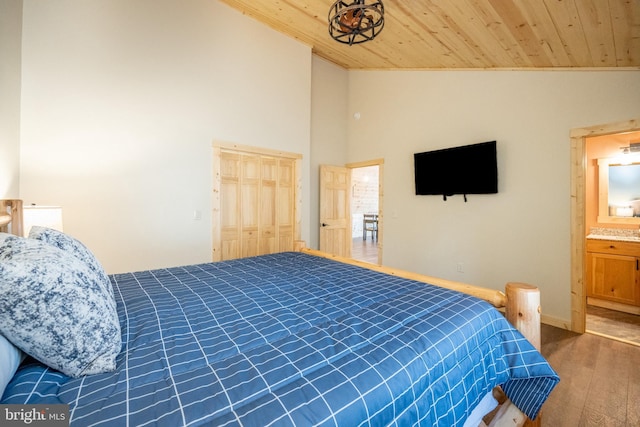 bedroom featuring wooden ceiling, high vaulted ceiling, connected bathroom, and dark hardwood / wood-style flooring