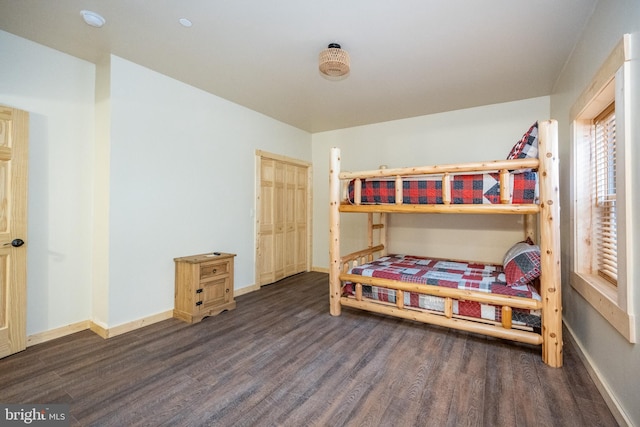 bedroom with dark hardwood / wood-style flooring