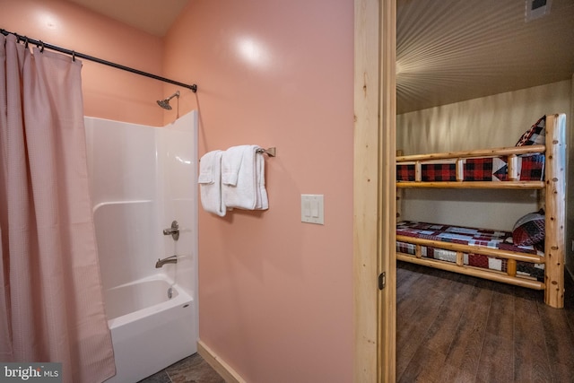 bathroom with shower / tub combo with curtain and wood-type flooring