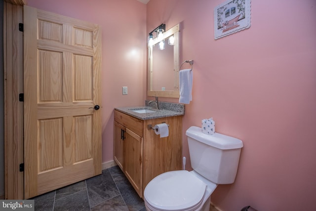 bathroom with toilet, tile floors, and large vanity