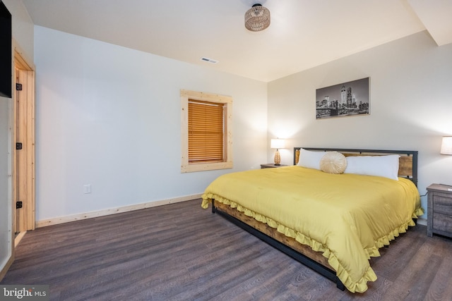 bedroom with dark hardwood / wood-style flooring