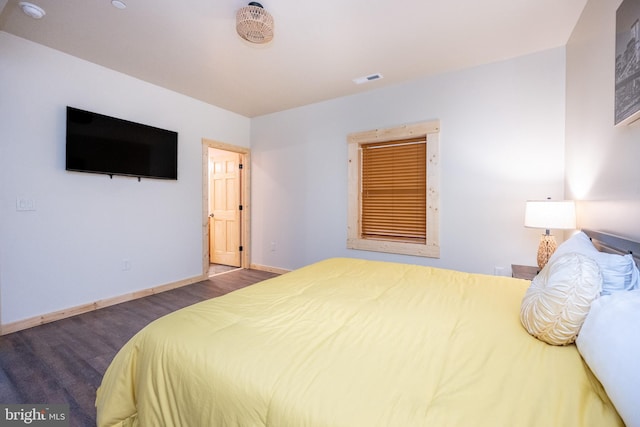 bedroom with dark wood-type flooring