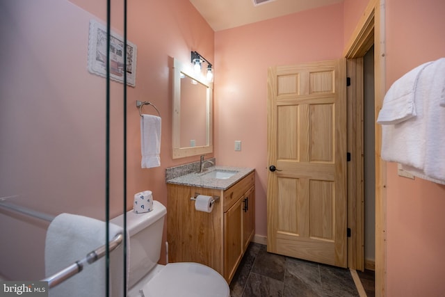 bathroom with tile flooring, vanity, and toilet