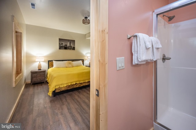 bedroom with dark wood-type flooring and a closet