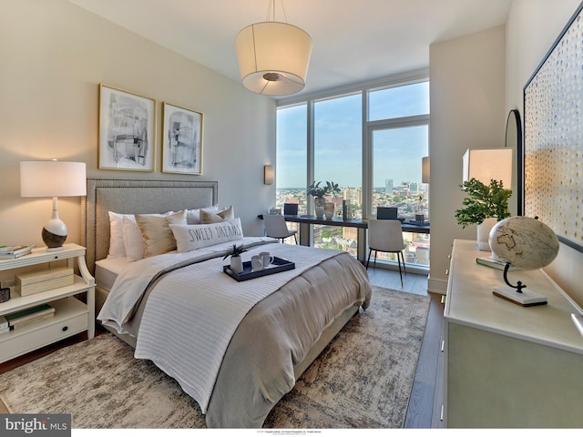 301 S Broad Unit 804, Philadelphia, PA 19107 - bedroom featuring hardwood / wood-style floors, a wall of windows, and multiple windows