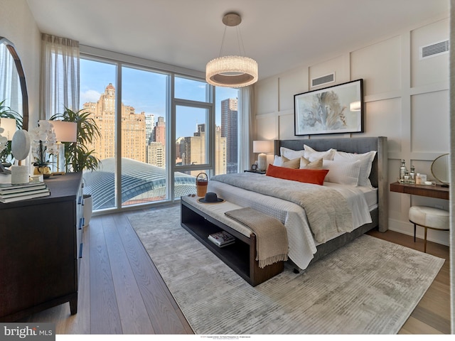 301 S Broad Unit 804, Philadelphia, PA 19107 - bedroom featuring floor to ceiling windows, hardwood / wood-style floors, and access to outside