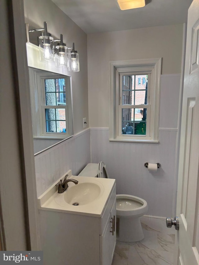 3820 V St SE Unit 202, Washington, DC 20020 - bathroom with marble look tiles, wainscoting, and vanity
