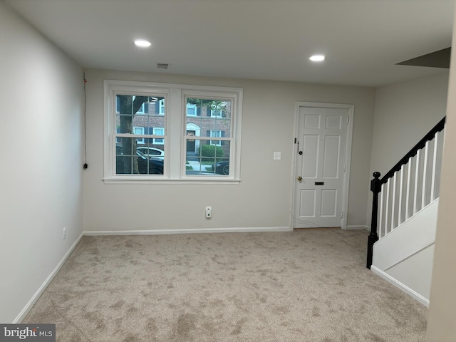 view of carpeted foyer entrance