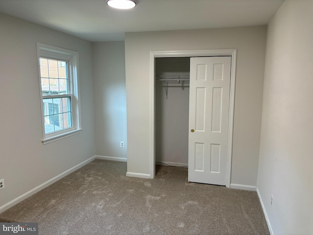 unfurnished bedroom with carpet floors and a closet