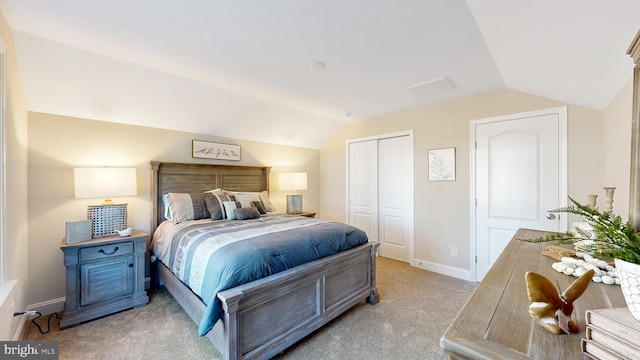 carpeted bedroom with lofted ceiling