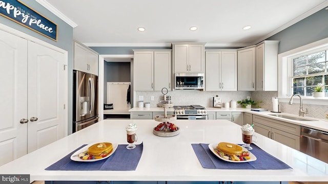 kitchen featuring gray cabinetry, ornamental molding, appliances with stainless steel finishes, sink, and tasteful backsplash