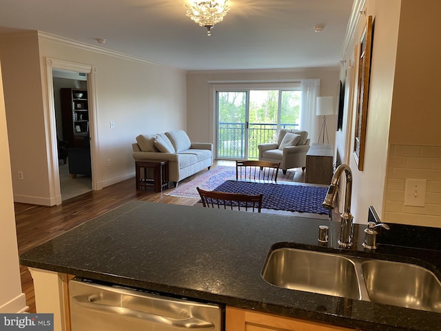 kitchen featuring dark stone counters, stainless steel dishwasher, crown molding, sink, and dark wood-type flooring