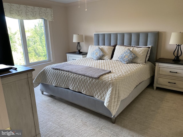 bedroom featuring light carpet and crown molding