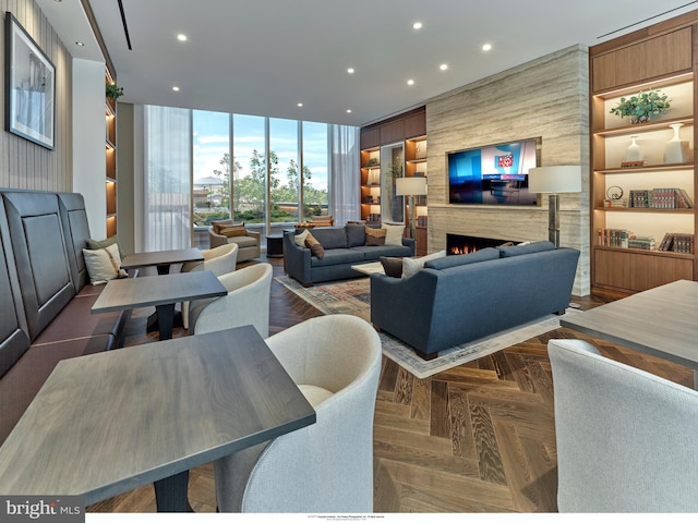 living room with dark parquet flooring and a fireplace