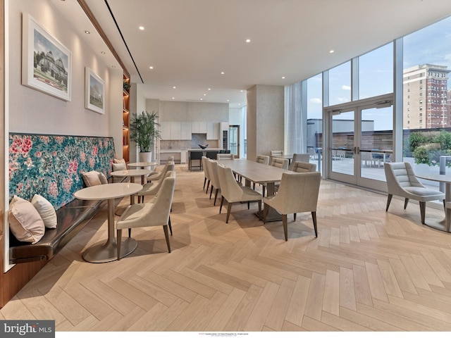 dining space with light parquet floors and expansive windows