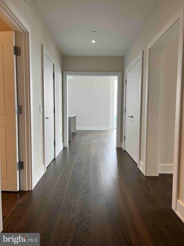 hall with dark wood-type flooring