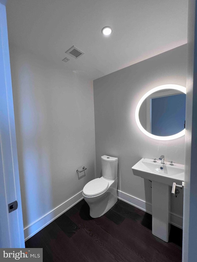 bathroom featuring toilet and hardwood / wood-style flooring