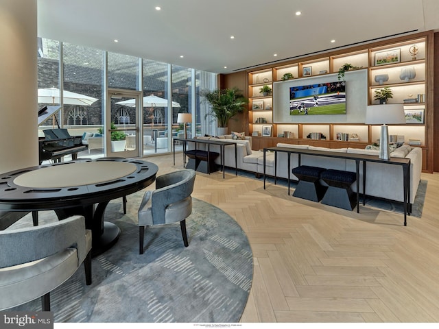 dining space with light parquet floors, plenty of natural light, and expansive windows