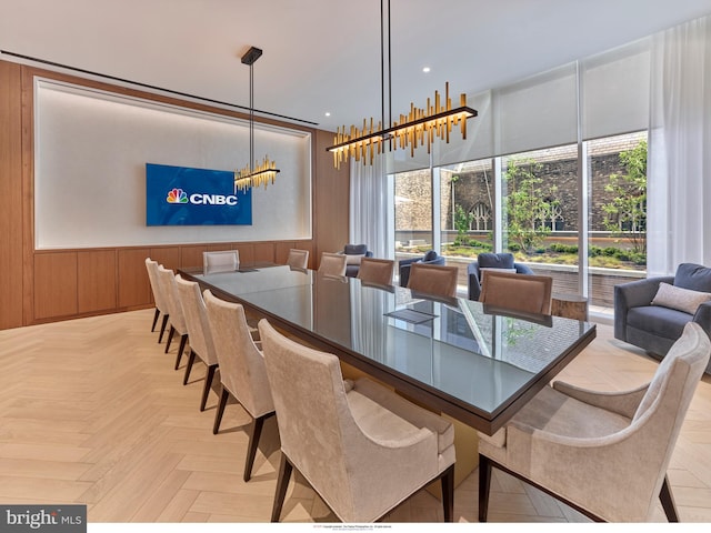 dining room with a chandelier, light parquet floors, and plenty of natural light