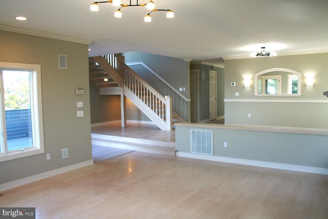 1707 Bay St, Fenwick Island, DE 19944 - unfurnished living room with a chandelier, crown molding, wood finished floors, and visible vents