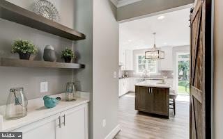4712 Carroll Manor Rd, Baldwin, MD 21013 - bar featuring light wood-type flooring, decorative light fixtures, a chandelier, and baseboards