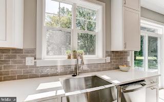 4712 Carroll Manor Rd, Baldwin, MD 21013 - kitchen featuring a sink, light countertops, dishwasher, and white cabinetry