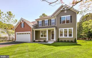 view of front of property with a front yard and a garage