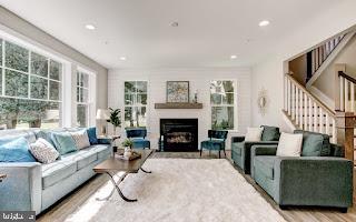4712 Carroll Manor Rd, Baldwin, MD 21013 - living area featuring a fireplace, stairs, wood finished floors, and recessed lighting
